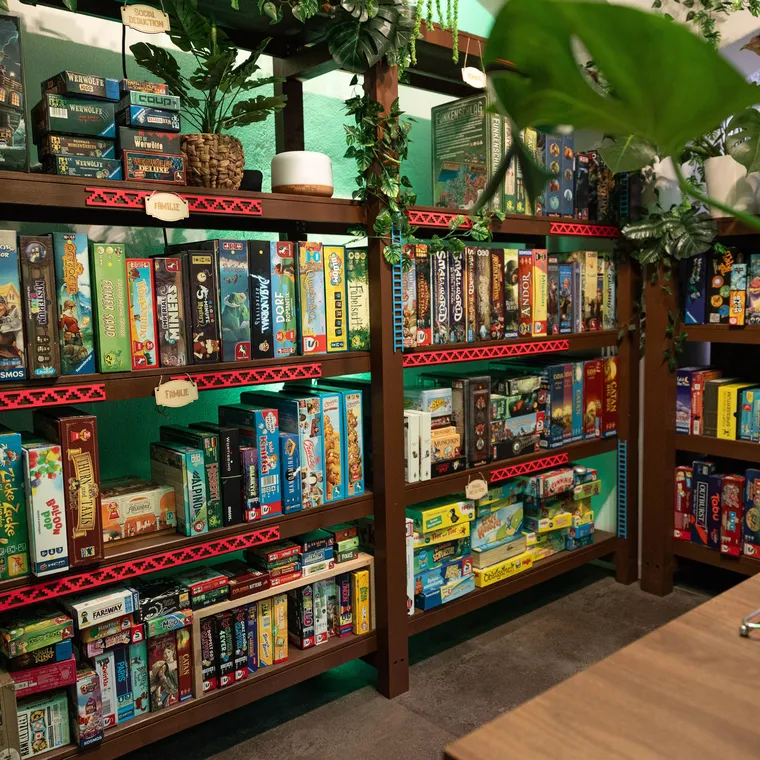 Das Spieleregal im Dschungel zwischen Monstera und Ranken